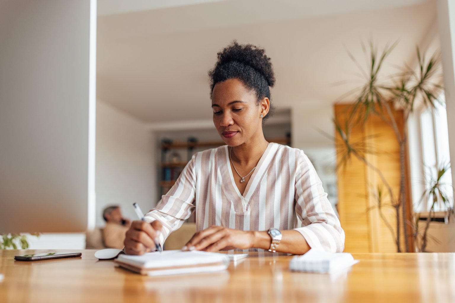 A woman organizing her busy schedule at a desk