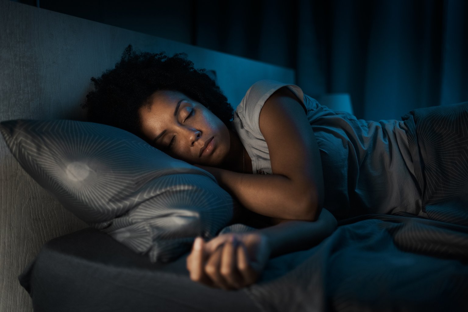 A woman sleeping peacefully in bed at night