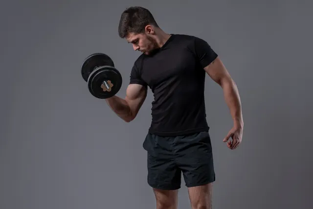 Athlete performing a dumbbell bicep curl