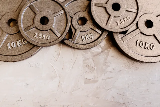 Weight plates stacked in ascending order in a gym
