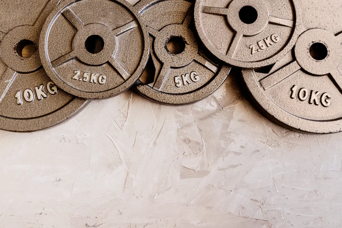 Weight plates stacked in ascending order in a gym