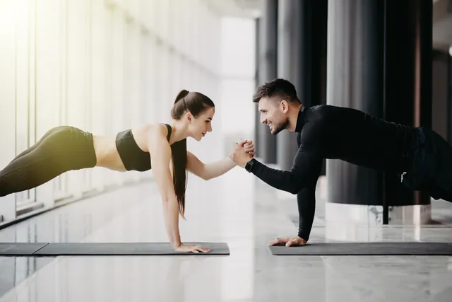 Two athletes training together, exercises paired back-to-back